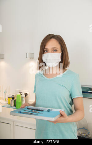 Dental assistant holding tray of tools at the dental clinic, Munich, Bavaria, Germany Stock Photo