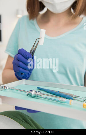 Dental assistant holding tray of tools at the dental clinic, Munich, Bavaria, Germany Stock Photo