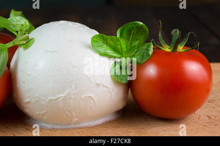 buffalo mozzarella with red tomatoes and fresh basil Stock Photo