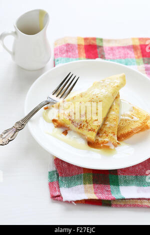 pancakes with condensed milk on plate Stock Photo