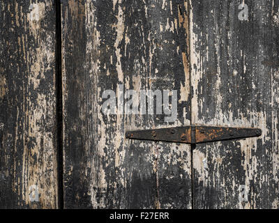 old rusty hinge on black wooden door Stock Photo