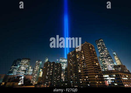 The Tribute in Light over buildings in Manhattan at night, in Lower Manhattan, New York. Stock Photo