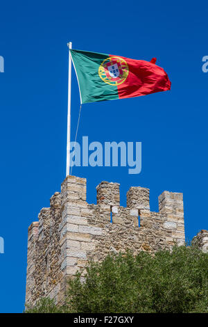 Flag flying over the Moorish Castle of S. Jorge on the hilltop in Lisbon, Portugal Stock Photo