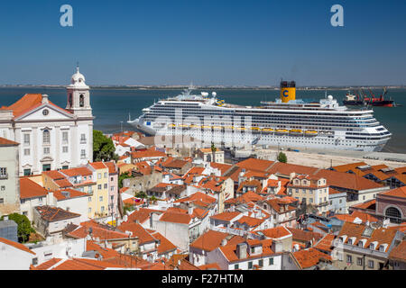 Costa Magica cruise ship alongside the Alfama district of Lisbon, Portugal Stock Photo