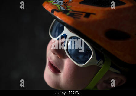 EAGLESHAM, SCOTLAND - AUGUST 28: a general view of a young male child cycling on a cycle track amongst wind turbines on Scottish Stock Photo