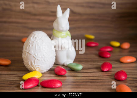 Close-up of an easter egg with easter bunny and candies Stock Photo