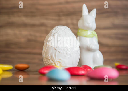 Close-up of an easter egg with easter bunny and candies Stock Photo