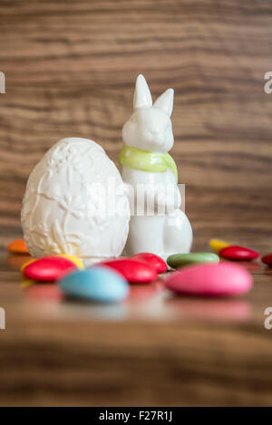 Close-up of an easter egg with easter bunny and candies Stock Photo