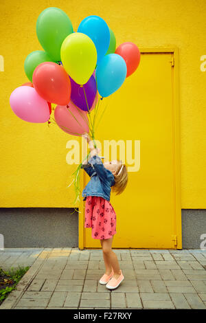 happy little girl outdoors with balloons Stock Photo