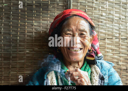 Portrait of a Nepali senior woman smoking and smiling, Nepal Stock Photo