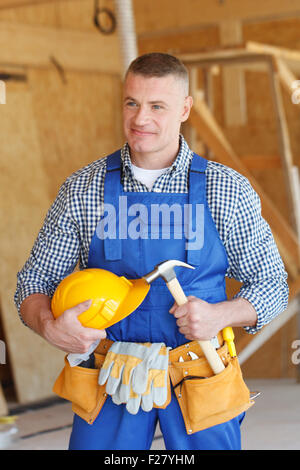 portrait of workman with hammer and helmet Stock Photo