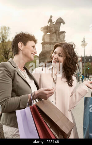 Two mature women shopping in the city, Bavaria, Germany Stock Photo