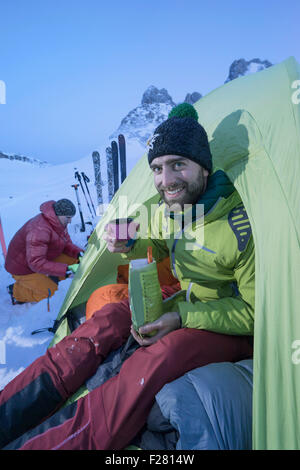 Man having dinner at bivouac camp, Tyrol, Austria Stock Photo