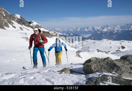 Ski mountaineers climbing on snowy mountain, Zell am See, Austria Stock Photo