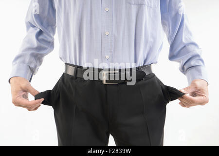 businessman showing out his empty pockets, Bavaria, Germany Stock Photo