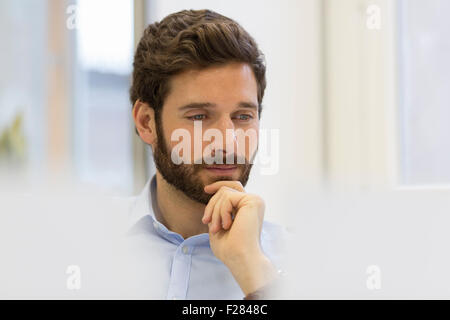 Pensive businessman in modern office Stock Photo