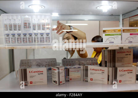 Phnom Penh, Cambodia. 14th Sep, 2015. A saleswoman prepares medical products during a pharmaceutical expo in Phnom Penh, capital of Cambodia, on Sept. 14, 2015. Cambodia organized the first international exhibition on the pharmaceutical and medical industry on Monday in a bid to boost the development of this fledgling sector, officials said. © Sovannara/Xinhua/Alamy Live News Stock Photo