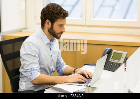 Professional businessman typing presentation work on laptop Stock Photo