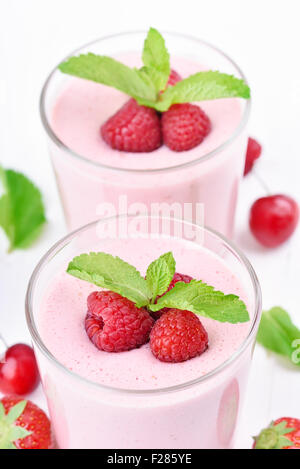 Glasses of raspberry milk shake with berries, close up view Stock Photo