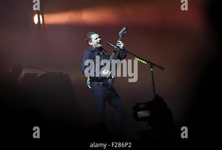 Berlin, Germany. 13th Sep, 2015. Musician Matthew Bellamy of British band Muse performs in stage during the Lollapalooza music festival on the former Tempelhof airport in Berlin, Germany, 13 September 2015. Photo: Britta Pedersen/dpa/Alamy Live News Stock Photo