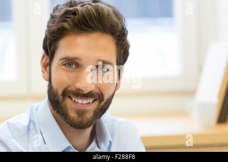 Portrait of handsome bearded man in office. looking camera Stock Photo