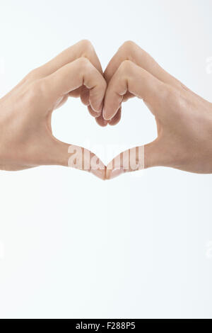 Close-up of woman's hands making heart shape, Bavaria, Germany Stock Photo
