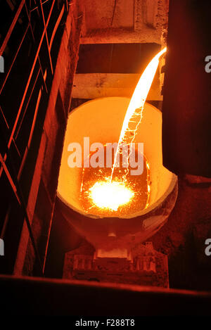 Molten metal poured from ladle Stock Photo