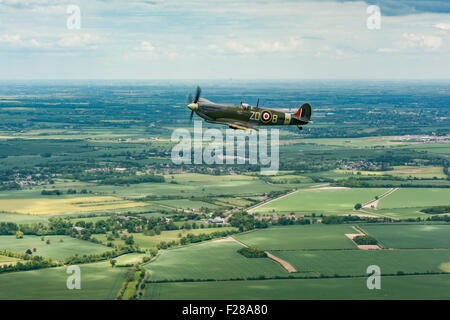 Supermarine Spitfire Mark IX MH434 originally of 222 Squadron Royal Air Force, flying over the Cambridgeshire countryside. Stock Photo