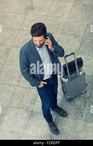 Modern casual business man on cell phone in hall airport. Top View Stock Photo