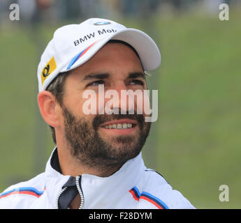 Oschersleben, Germany. 13th Sep, 2015. BMW pilot Timo Glock smiles prior to the DTM (German Touring Car Masters) race at etropolis Arena in Oschersleben, Germany, 13 September 2015. Photo: Jens Wolf/dpa/Alamy Live News Stock Photo
