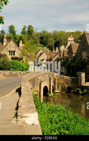 Picturesque cottages beside the bridge over the By Brook in the village of Castle Combe. Stock Photo