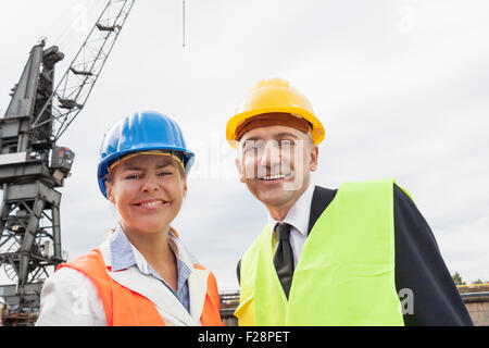 Portrait of business people at harbour and smiling, Hamburg, Germany Stock Photo