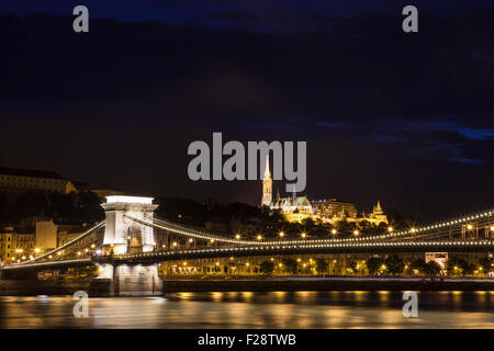 A beautiful night-time view of the Chain Bridge spanning the River Danube with the Fisherman’s Bastion and St. Matthias Church i Stock Photo