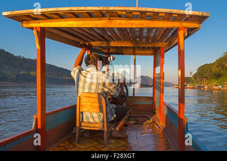 Riverboat captain on Mekong river, Luang Prabang, Laos Stock Photo
