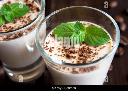 Chocolate Panna Cotta dessert with mint in portion glasses close up Stock Photo