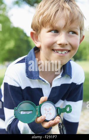 Close-up of a boy holding a navigational compass, Bavaria, Germany Stock Photo