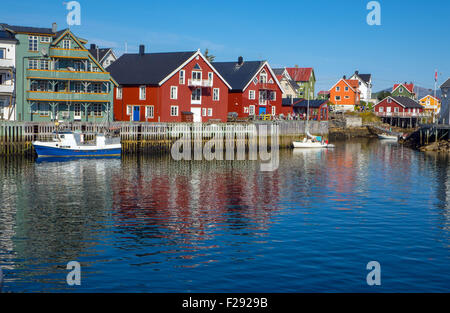 Red waterside fishing houses, Rorbu, on wooden stilts, with reflections Stock Photo