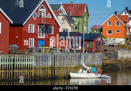 red waterside fishing houses, Rorbu, on wooden stilts, with reflections Stock Photo