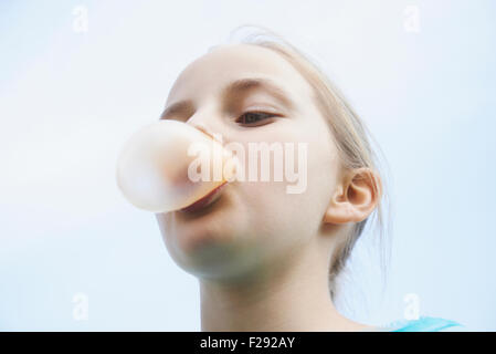 Girl blowing chewing gum bubble, Bavaria, Germany Stock Photo