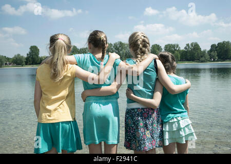 Group of friends standing in the lake, Bavaria, Germany Stock Photo