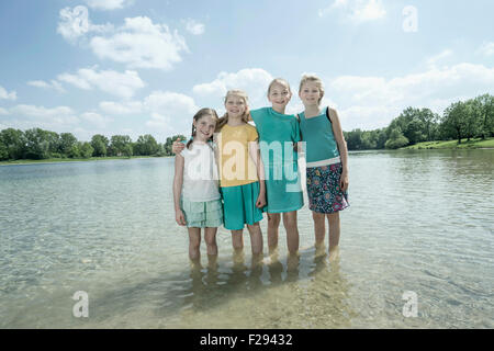 Group of friends standing in the lake, Bavaria, Germany Stock Photo