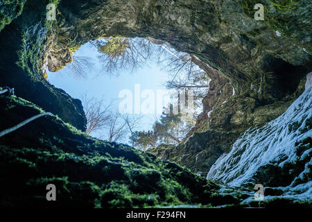 Huge karst cave entrance from below Stock Photo