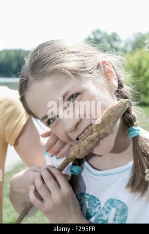 Close-up of girl eating sausage, Bavaria, Germany Stock Photo