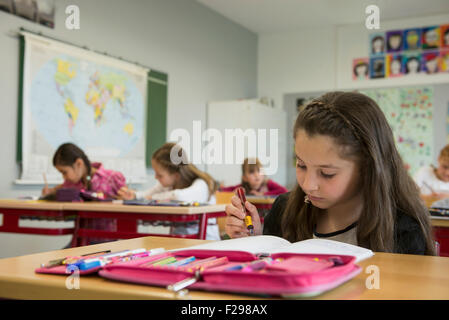 schoolgirls writing notebooks, Munich, Bavaria, Germany Stock Photo