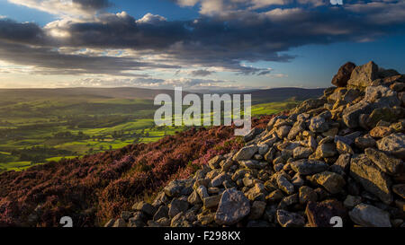 Beautiful sunset scene with views from high up at the cairn on Beamsley Beacon in gorgeous dramatic evening light, North Yorkshire, England, UK