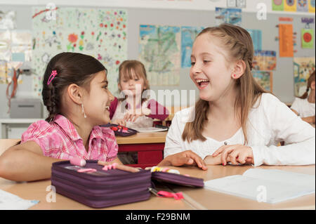 schoolgirls talking in classroom, Munich, Bavaria, Germany Stock Photo