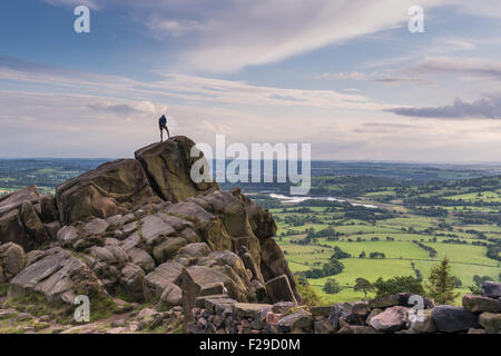 A climber at the roaches with a view over Tittisworth, Peak District National Park Stock Photo