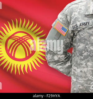 American soldier with flag on background series - Kyrgyzstan Stock Photo