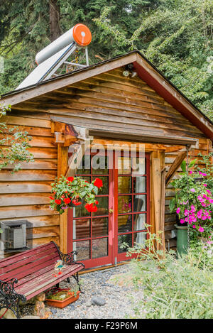 Cabin with solar water heater on roof, Sailboats, Sunshine Coast, ,British Columbia, Canada Stock Photo