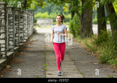 Running. Young woman Jogging in the Park. Morning jog. Healthy lifestyle. Stock Photo